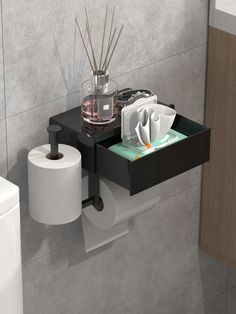 there is a toilet paper holder on the wall with tissue and toothbrushes in it