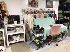 a room filled with lots of clothes and furniture