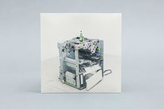 a white card with an image of a machine on it's front and back sides