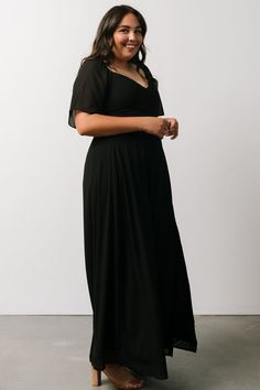 Our cute maxi dress is made of lightweight chiffon material and comes in our classic black color. This dress has a smocked back bodice and a sweetheart neckline. Evening V-neck Maxi Dress With Smocked Back, Chiffon Maxi Dress With Smocked Back, Black V-neck Dress With Smocked Back, Fitted Chiffon Maxi Dress With Smocked Back, Black Flowy Maxi Dress With Flutter Sleeves, Flowy Black Maxi Dress With Flutter Sleeves, V-neck Chiffon Dress With Smocked Bodice, Elegant Black Maxi Dress With Smocked Bodice, Fitted Black Chiffon Dress For Date Night