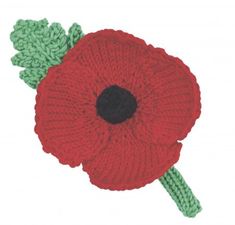 a knitted red flower with green leaves