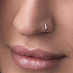 a woman's nose with a small nose ring on top of her nose and the bottom