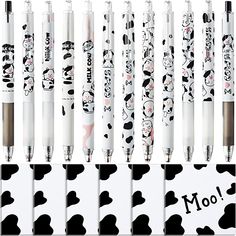 several pens are lined up next to each other with different designs on them and the words moo written in black ink