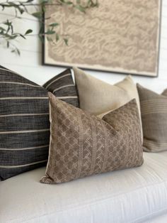 four decorative pillows on a white couch