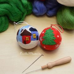 two balls of yarn and a needle on a table