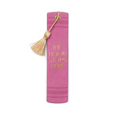 the book stops here tasseled bookmark in pink with gold foil lettering on it