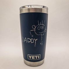 a yeti cup with the words daddy written on it