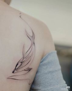 a woman with a tattoo on her shoulder