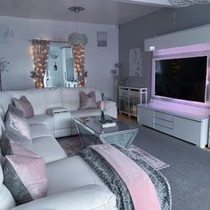 a living room filled with furniture and a flat screen tv mounted on the wall above it