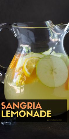 a pitcher filled with lemonade and sliced apples