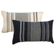 two black and white pillows on a white background