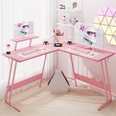 a pink computer desk with two monitors on it