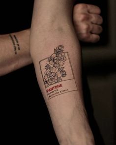 a person's arm with a tattoo on it that says pantone and flowers