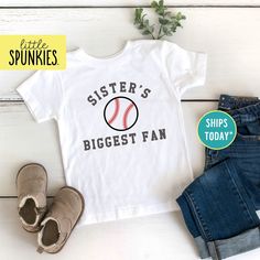 Baseball Season Shirts for Kids, Sisters Biggest Fan Toddler T-Shirt, Game Day Shirts PRODUCTION TIME Little Spunkies from the designer/owner of Spunky Pineapple Co https://www.etsy.com/shop/SpunkyPineappleCo   All baby and toddler clothes are 100% designed and printed with water based ink. All orders placed before 12:00 pm EST are shipped out same day (Monday - Friday). Orders received after noon are shipped out the next business day. ONESIES® BRAND  Made from 100% Cotton. We print on Onesies® Brand and do recommend ordering up one size as these run a little small after washing. T-SHIRT Made from 100% Cotton. These run true to size. If you are in between sizes we suggest sizing up. RAGLAN Made from 52% Cotton / 48% Polyester. These run true to size. If you are in between sizes we suggest Varsity Style T-shirt For Baseball Season, Baseball Season Fan Merchandise Tops With Team Spirit, Crew Neck Baseball Jersey With Name Print For Fans, Baseball Season Tops With Team Name For Fan Merchandise, Team Name Tops For Baseball Season Fan Merchandise, Baseball Season Fan Merchandise Top With Team Name, Fan Merchandise Tops With Team Name For Baseball Season, Sports Season Fan Gear Baseball Jersey With Letter Print, Cotton Baseball Jersey For Fans