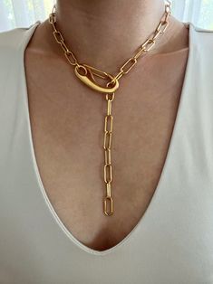 Chunky gold paperclip lariat featuring a large clasp. Necklace can clasp anywhere on the chain for different looks. Necklace is gold plated stainless steel. It is of great importance to me that I make jewelry for my customers that I, myself, wear every day. Each jewelry piece is handmade by me personally with love and care. Each item is crafted to the highest quality and made to exceed the expectations of my customers. My jewelry is designed to you to love and wear no matter what the occasion at Elegant Chunky Chain Lariat Necklace, Elegant Lariat Chain Necklace With Lobster Clasp, Elegant Lariat Necklace With Chunky Chain, Metal Lariat Necklace With Chain, Metal Lariat Necklace With Chunky Chain, Metal Lariat Necklace With Chain Detail, Metal Lariat Necklace, Chunky Chain Metal Lariat Necklace, Chic Paperclip Chain Lariat Necklace