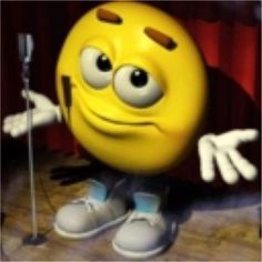 a yellow smiley face with arms and legs in front of a red curtain