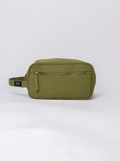 We built our toiletry bag out of heavy-duty organic cotton, making it the most eco-friendly toiletry bag we know how to make. Our toiletry bag is a real workhorse for its size, offering ample storage space for toiletries, cosmetics or any other gear you want to wrangle and organize. Made with 14-oz Certified Fairtrade Organic cotton canvas Long pull zipper Carry handle Bag: H5.5 x W10 x D5 inches Front Pocket: H4 x W10 inches Handle drop: 4.25 inches Your purchase also supports Feeding America's Green Functional Cosmetic Bag For Everyday Use, Eco-friendly Cotton Pouch For Daily Use, Eco-friendly Cotton Daily Use Pouch, Everyday Rectangular Canvas Cosmetic Bag, Rectangular Cotton Travel Cosmetic Bag, Feeding America, Handle Bag, Toiletry Bag, Storage Space