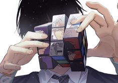 an anime character holding up cubes to his face