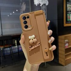 a woman holding up her phone case with an ice cream sticker on it