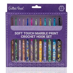 an assortment of colorful crochet hooks in a purple box with the words, soft touch marble print crochet hook set