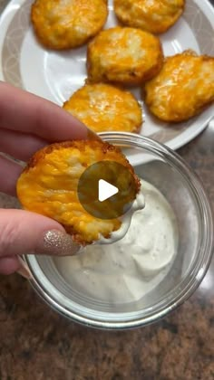 a person is dipping some food into a bowl