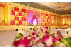 a decorated stage with flowers in front of it