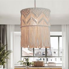 a dining room table and chairs with a chandelier hanging from the ceiling