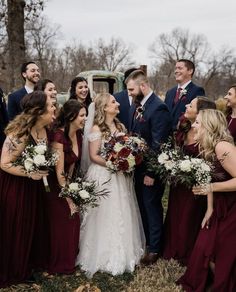 a group of people standing next to each other in front of a truck with flowers