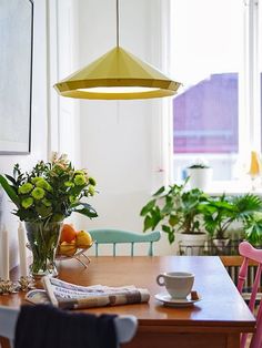 a wooden table topped with a vase filled with flowers