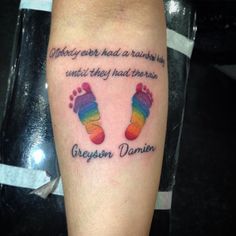 a person with a tattoo on their leg that says, nobody ever had a rainbow in it until they had the rain