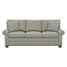 a gray couch with two pillows on it's back and one arm facing the camera