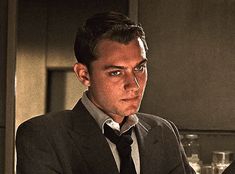 a man in a suit and tie sitting at a table