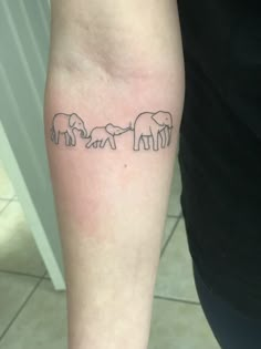 an elephant family tattoo on the left arm and leg, with three elephants in line