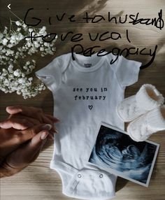 a baby's bodysuit, socks and flowers on a wooden table with the words give vcol pelegcy