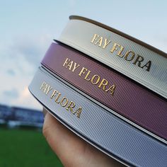 a person holding four different colored belts in their hands with the words bay flora on them