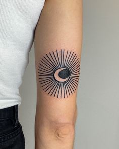 a person with a tattoo on their arm that has an eyeball in the middle