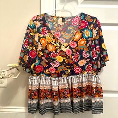 Shein Ladies Boho Blouse Features Short Sleeves In Babydoll Style. Very Full Style. Would Easily Fit A Large. Navy, Ivory, Rust, Cranberry, Teal And Yellow Floral Design. Very Fun. Never Worn. New Without Tags. Multicolor Floral Print V-neck Peasant Top, Multicolor Floral Print V-neck Top, Multicolor Floral Print V-neck Blouse, Multicolor V-neck Blouse With Floral Print, Bohemian Multicolor V-neck Top, Flowy Multicolor Floral Print Blouse, Flowy Multicolor Floral Print Tops, Bohemian V-neck Multicolor Print Blouse, Bohemian Multicolor Vibrant Print Tops