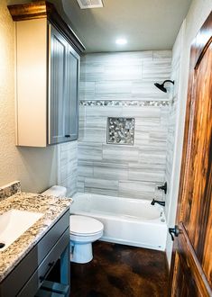 a bathroom with a sink, toilet and bathtub