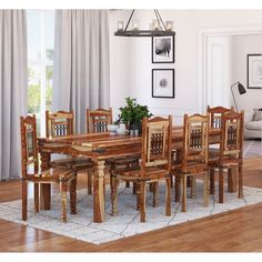 a dining room table and chairs in front of a window