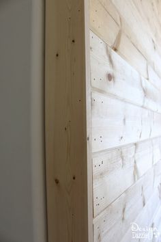 the corner of a wall made out of wood