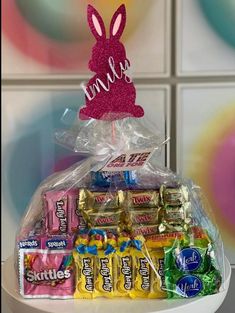 a basket filled with candy and candies on top of a table next to a wall