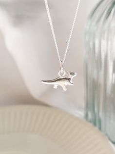 "This sterling silver necklace features the cutest little dinosaur charm! Small and dainty, this dinosaur necklace is suitable for everyday wear. The t-Rex charm comes with a sterling silver curb chain in the length of your choice!  Made from 925 sterling silver, which is hypoallergenic, lead and nickel free! This makes it a great choice for those with sensitive skin.  Length: 13 mm Width: 17 mm Chain Lenfth: 16\", 18\", 20\" Please contact us for any wholesale order inquiries. ----------------- Dinosaur Necklace Diy, Silver Novelty Charm Necklace, Dino Jewelry, Dinosaur Necklaces, Dinosaur Jewelry, Dinosaur Pendant, Dinosaur Necklace, Tiny Charm, Wholesale Jewelry