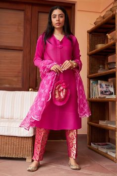 Magenta pink three fourth sleeves straight solid kurta in pleated polyester base with V neckline. Comes with floral brocade pant and sequin embroidered organza net dupatta and pleated hem brocade potli bag.
Components: 4
Pattern: Embroidery
Type Of Work: Sequin
Neckline: V Neck
Sleeve Type: Three Fourth Sleeves
Fabric: Kurta: Pleated Polyester, Pant: Brocade, Dupatta: Organza Net
Color: Pink
Other Details: 
Scallop hem dupatta
Sequin embroidered dupatta
Pleated hem brocade potli bag
Length:
Kurt Magenta Suit Design, Brocade Pants With Top, Brocade Pants Outfit, Brocade Suit Design, Brocade Pant Suit, Jago Outfit, Brocade Styles For Women, Indian Skirt And Top, Brocade Dupatta