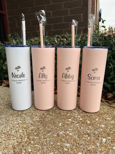 three pink and white tumblers sitting next to each other on top of a sidewalk