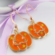 Cute Halloween Jack-o-lantern Charm Hook Earrings       Materials:     Earring Hooks - Copper   Charms - Alloy & Resin      Approx. Total Earring Length:  35mm Novelty Orange Earrings For Halloween, Gold Novelty Earrings For Halloween, Orange Novelty Halloween Jewelry, Spooky Orange Halloween Jewelry, Orange Dangle Earrings For Halloween, Handmade Gold Earrings For Halloween, Handmade Gold Halloween Earrings, Halloween Orange Nickel-free Earrings, Orange Nickel-free Earrings For Halloween