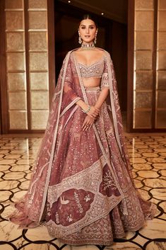 a woman in a red and white lehenga