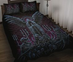 a bed covered in a black and red comforter