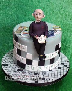 a cake made to look like an old man sitting on top of a checkered table