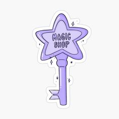 a purple star shaped key with the words magic shop written on it and an arrow pointing up