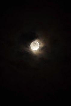 the full moon is seen through clouds in this dark night time photo taken on march 25, 2012